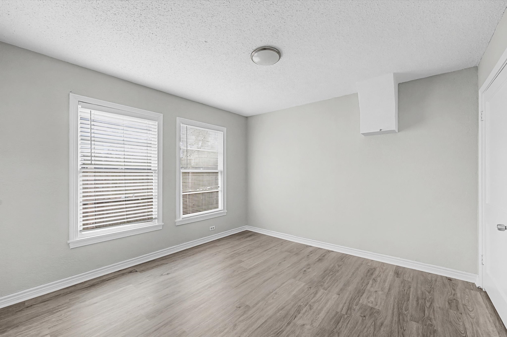 1108 Georgina Street Rosenberg, TX 77471 - Photo 11 of 15 an empty room with wooden floor and windows