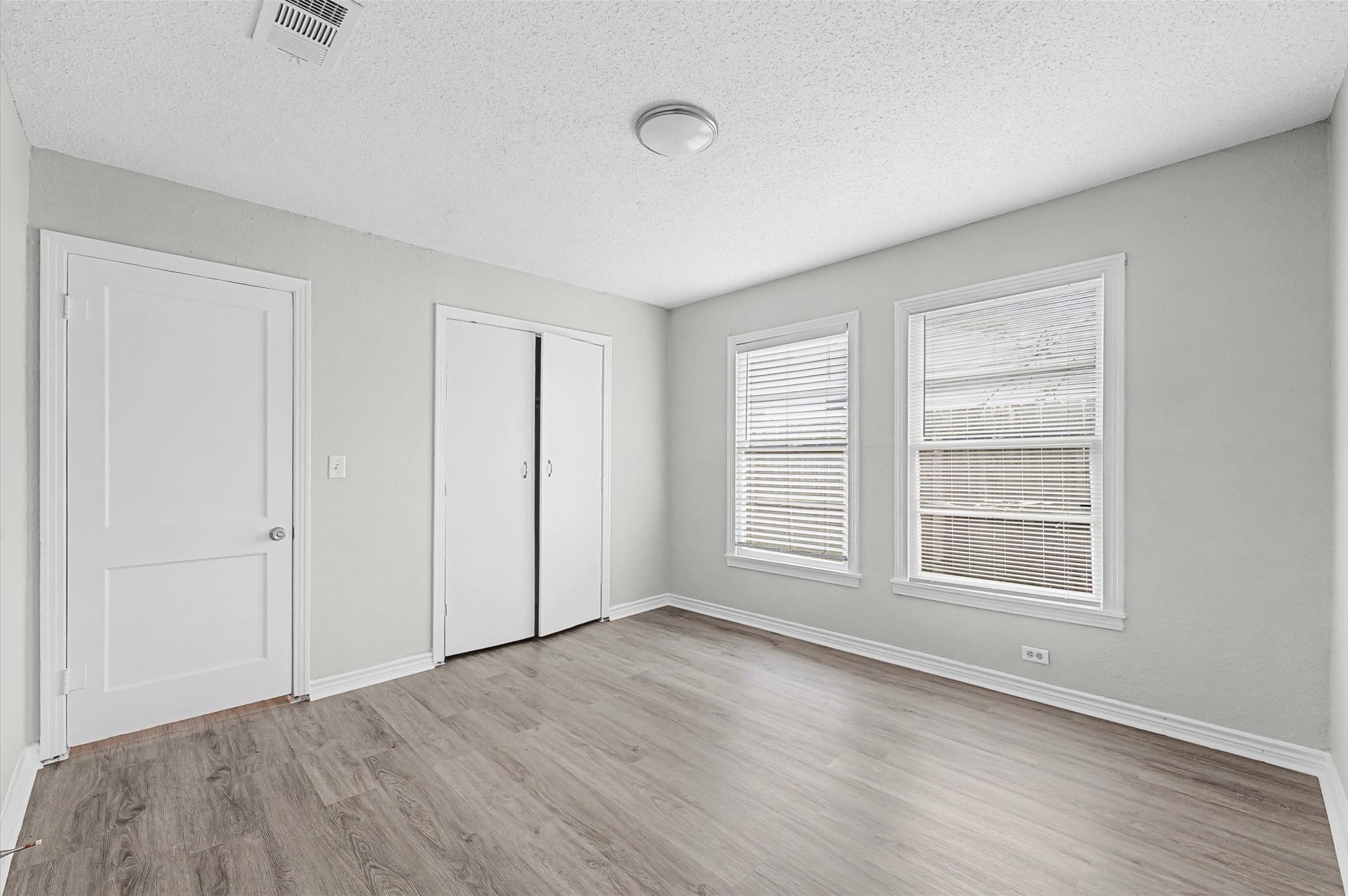 1108 Georgina Street Rosenberg, TX 77471 - Photo 12 of 15 an empty room with wooden floor and windows