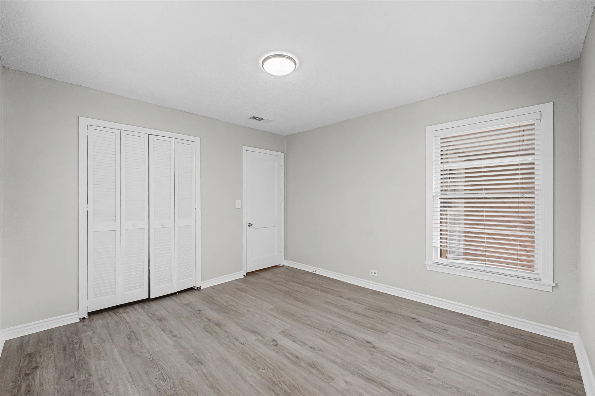 1108 Georgina Street Rosenberg, TX 77471 - Photo 14 of 15 a view of an empty room with wooden floor and a window