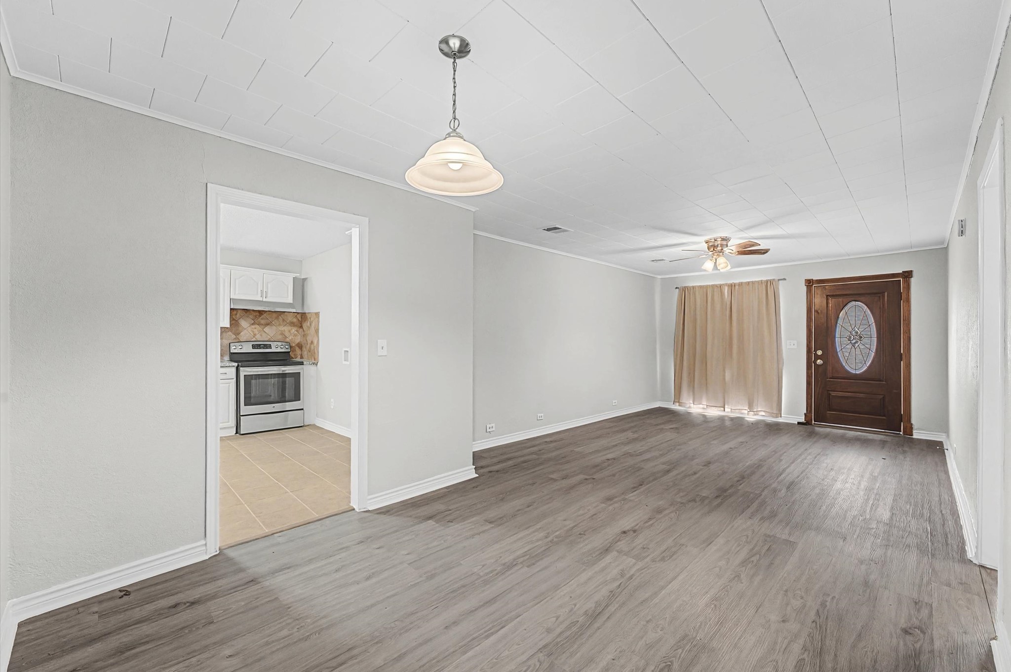 1108 Georgina Street Rosenberg, TX 77471 - Photo 4 of 15 a view of a livingroom with wooden floor and a ceiling fan