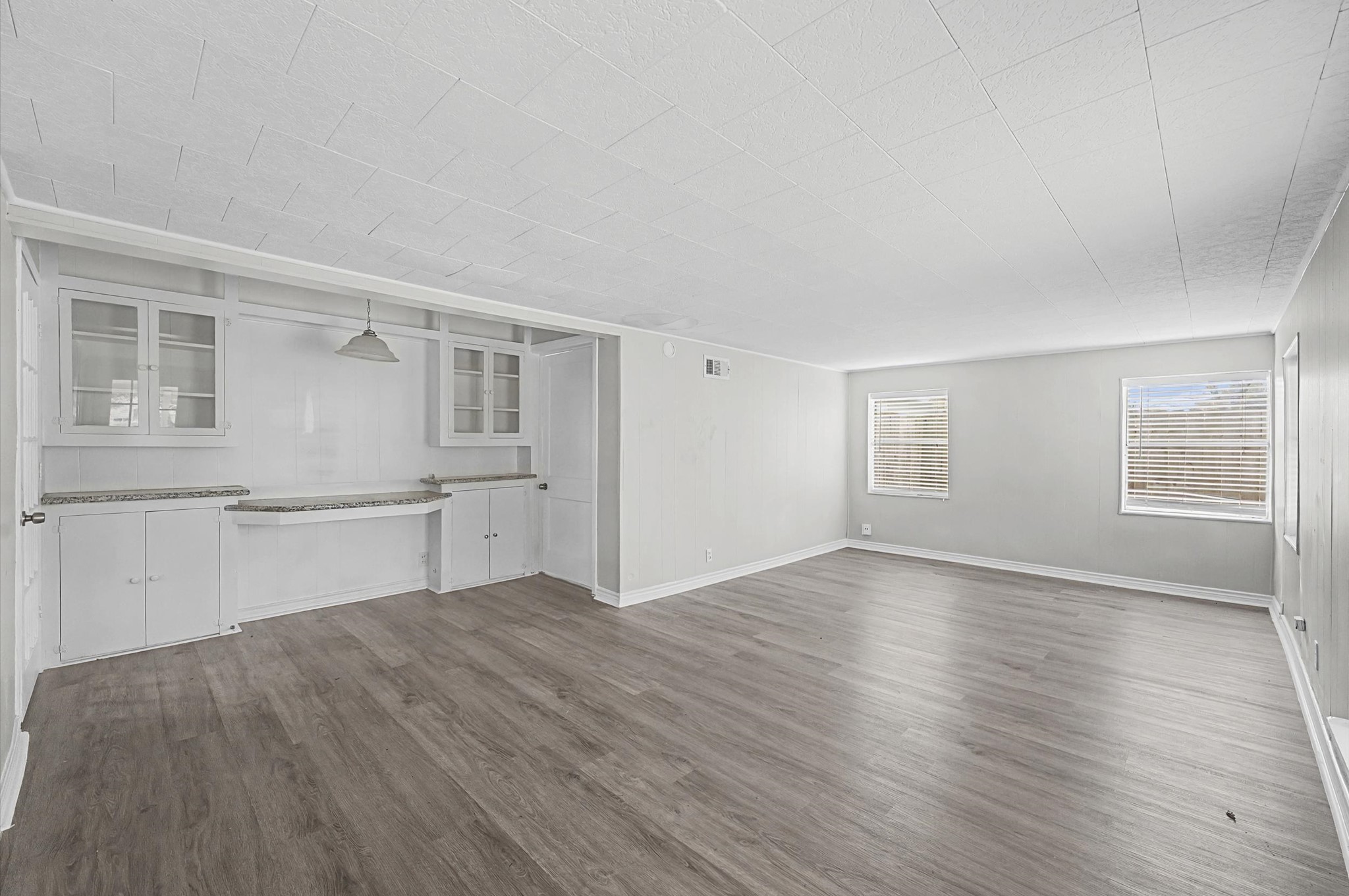 1108 Georgina Street Rosenberg, TX 77471 - Photo 10 of 15 an empty room with wooden floor and windows