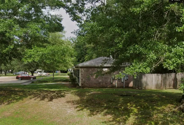 a view of a backyard with large trees