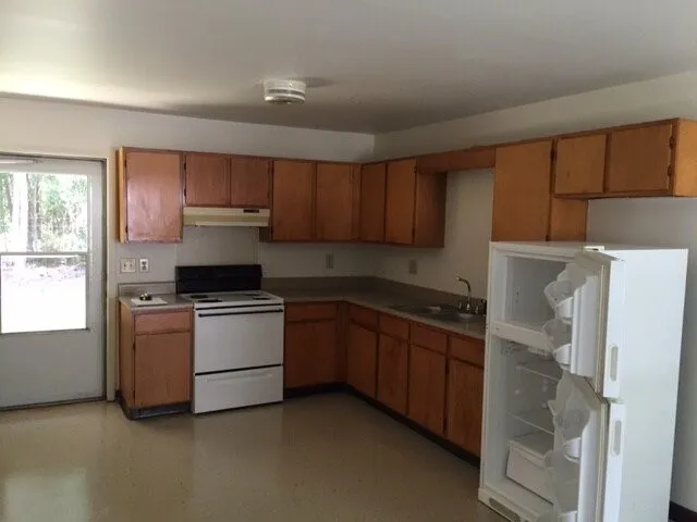 a kitchen with a sink a stove and refrigerator