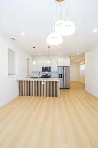 a view of kitchen and a refrigerator