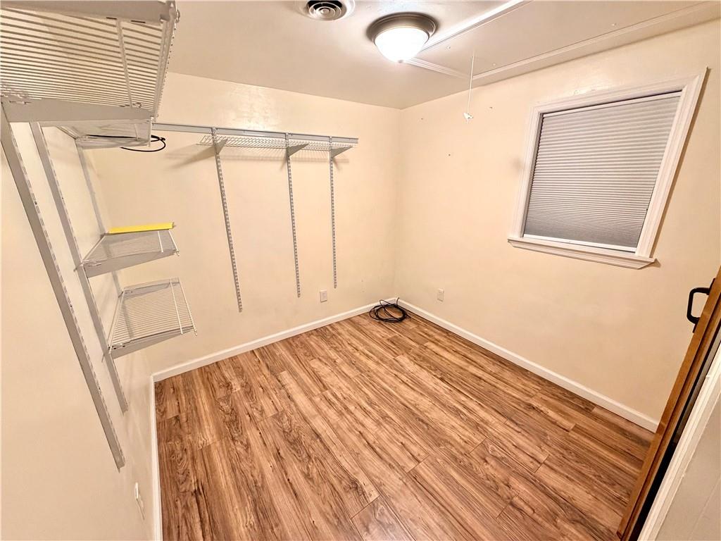 166 Jr Street Hopwood, PA 15445 - Photo 17 of 23 a view of empty room with wooden floor and window