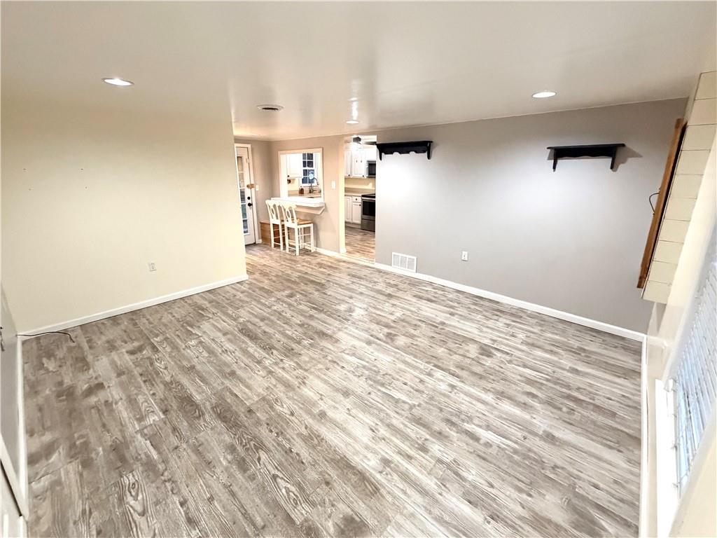 166 Jr Street Hopwood, PA 15445 - Photo 4 of 23 an empty room with wooden floor and windows