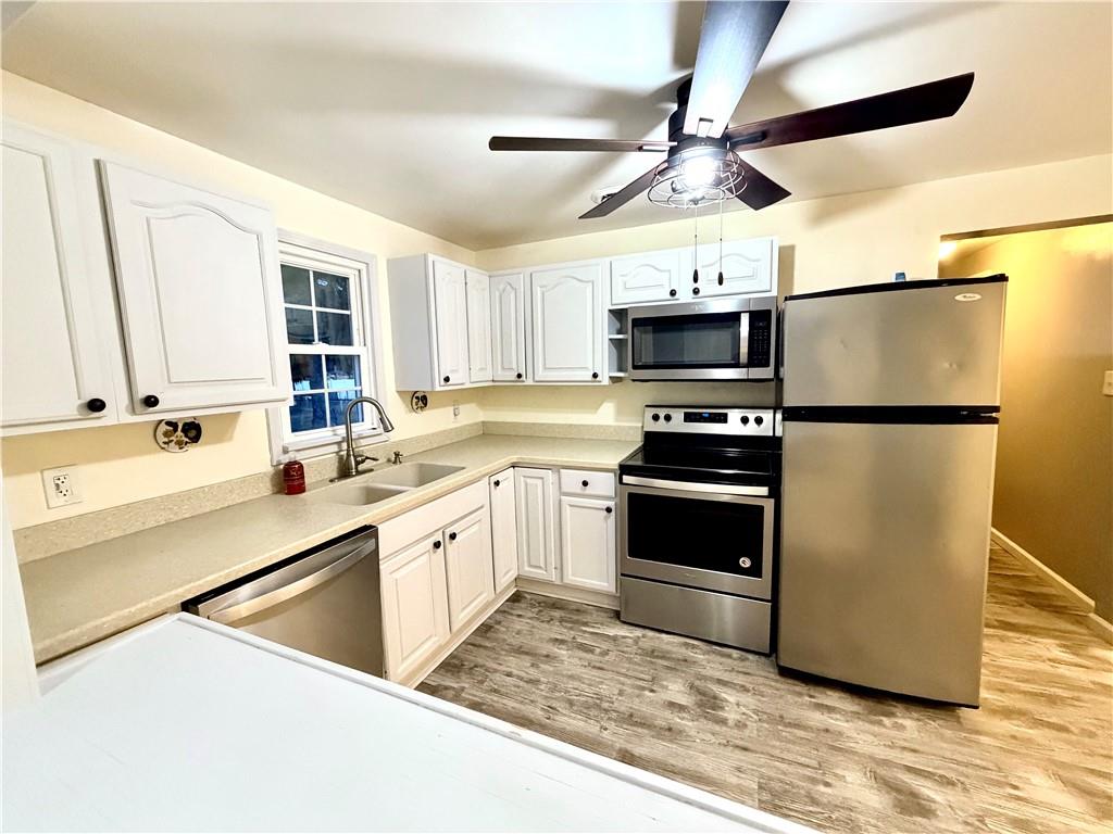 166 Jr Street Hopwood, PA 15445 - Photo 7 of 23 a kitchen with granite countertop a refrigerator and a sink