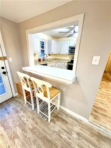 a dining room with wooden floor and a window