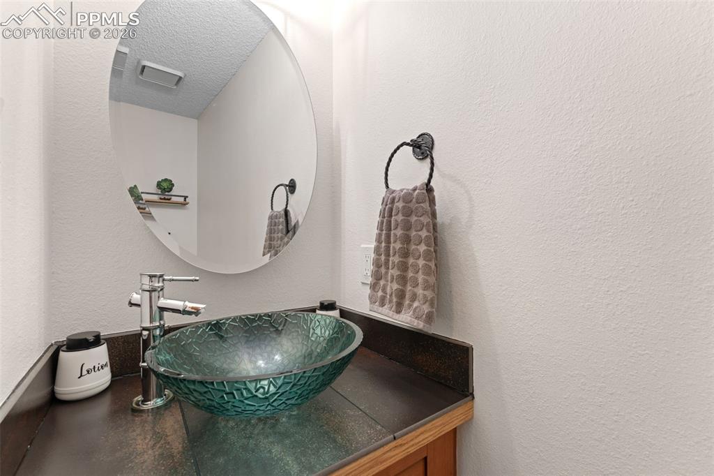 1851 Buttercup Road Elizabeth, CO 80107 - Photo 35 of 47 a room with a granite countertop a sink and a mirror