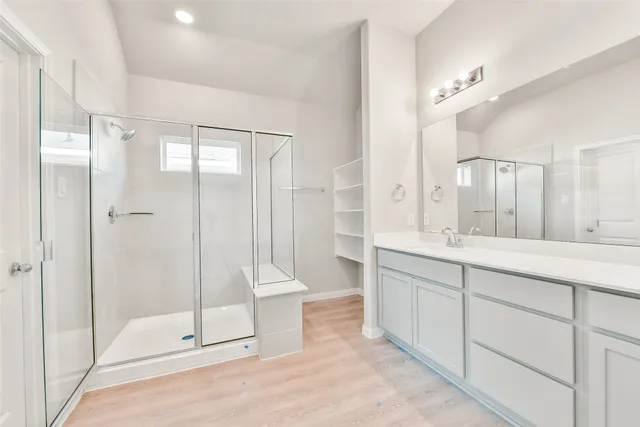 a spacious bathroom with a double vanity sink a mirror and a bathtub