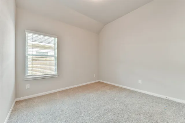a view of an empty room and closet area