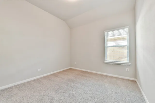 a view of an empty room and closet area