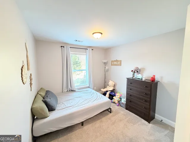 a bedroom with furniture and a window