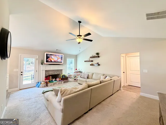 a living room with furniture and a flat screen tv