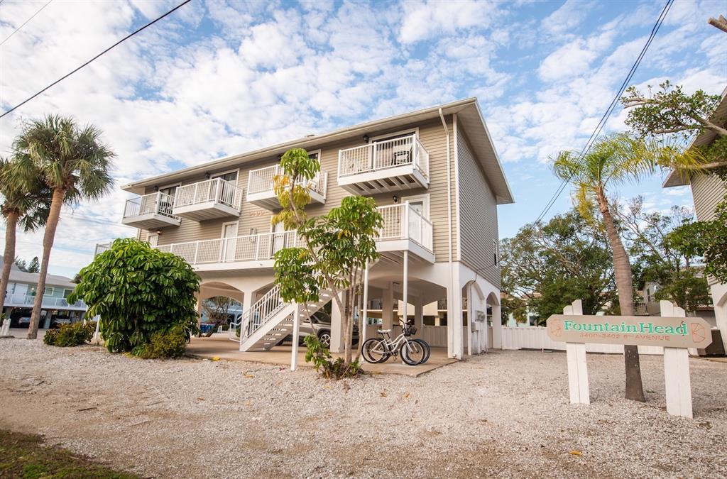 a view of a house with a yard and sitting area