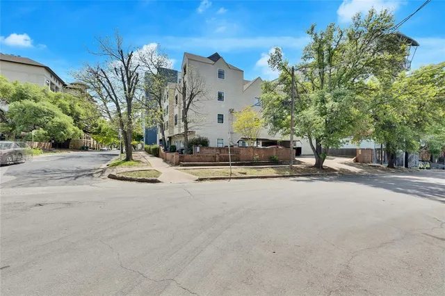 a view of building with parked cars