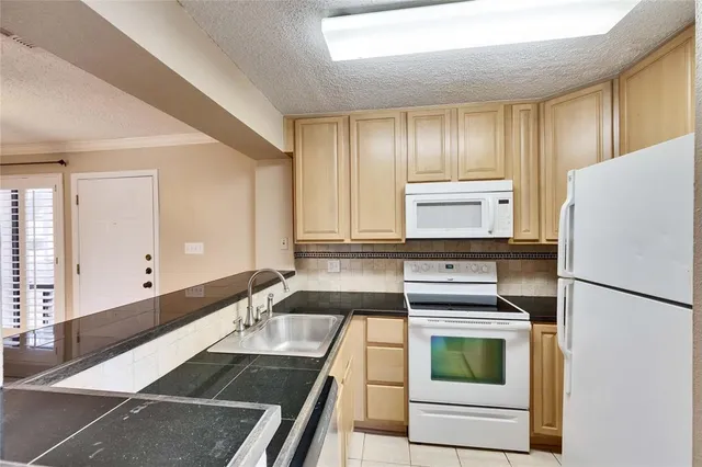 a kitchen with a refrigerator and a sink