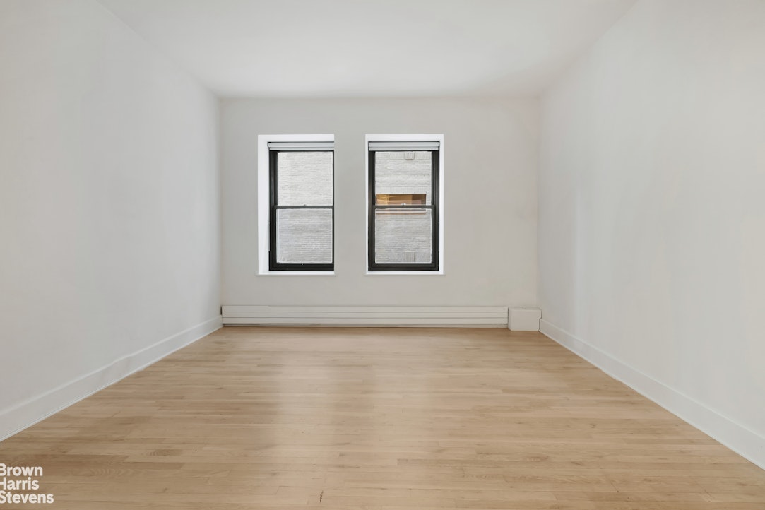 260 West Broadway, Unit 6D Manhattan, NY 10013 - Photo 10 of 15 wooden floor in an empty room with a window