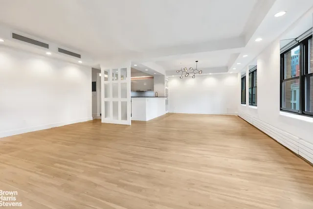 a view of empty room with wooden floor