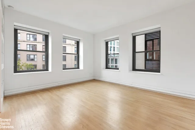 a view of an empty room with windows