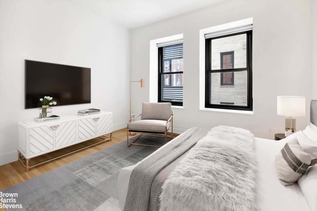 260 West Broadway, Unit 6D Manhattan, NY 10013 - Photo 6 of 15 a bedroom with a bed and a flat screen tv