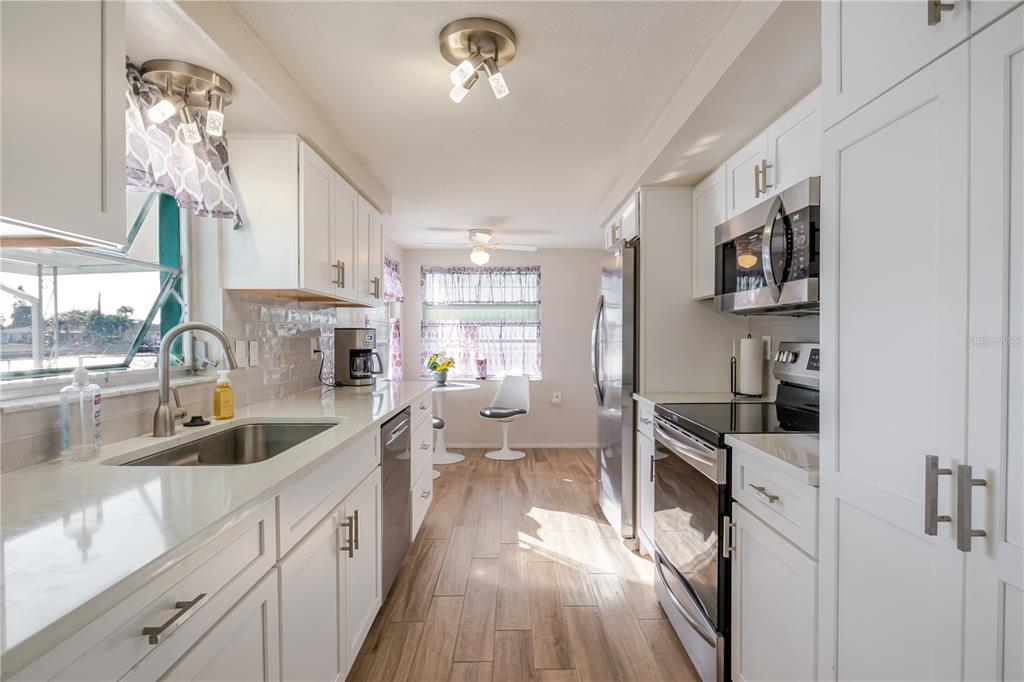 5644 Riddle Road Holiday, FL 34690 - Photo 11 of 58 a kitchen with sink cabinets and window