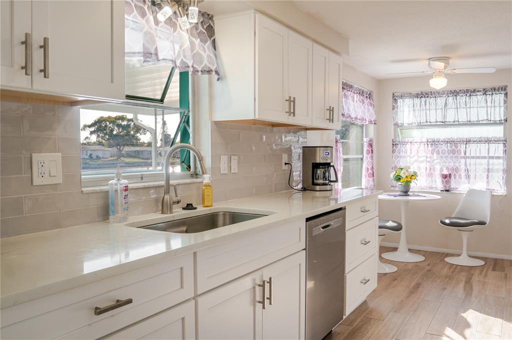 5644 Riddle Road Holiday, FL 34690 - Photo 12 of 58 a kitchen with white cabinets and window