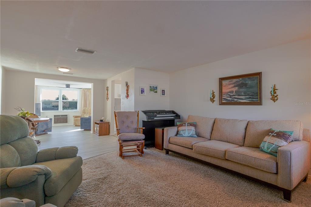5644 Riddle Road Holiday, FL 34690 - Photo 21 of 58 a living room with furniture and a large window