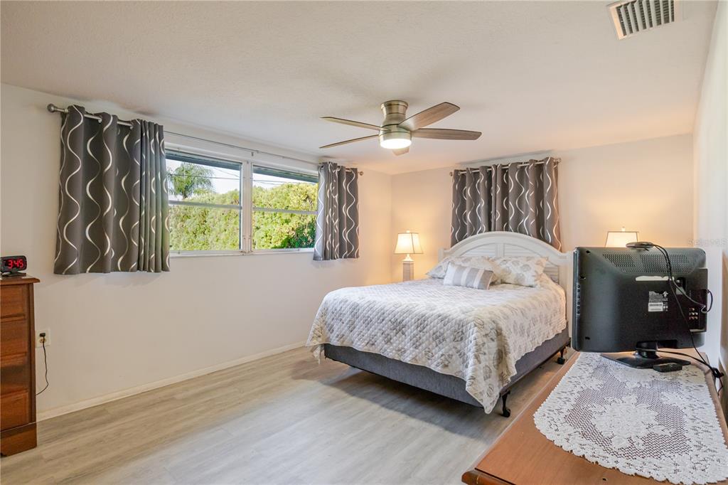 5644 Riddle Road Holiday, FL 34690 - Photo 22 of 58 a bedroom with a bed and wooden floor