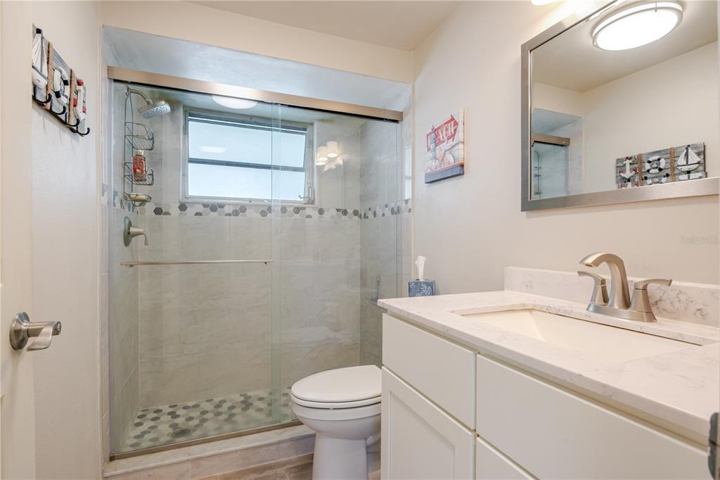 5644 Riddle Road Holiday, FL 34690 - Photo 25 of 58 a bathroom with a sink toilet and shower
