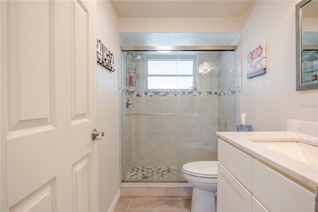 5644 Riddle Road Holiday, FL 34690 - Photo 26 of 58 a bathroom with a sink toilet and shower