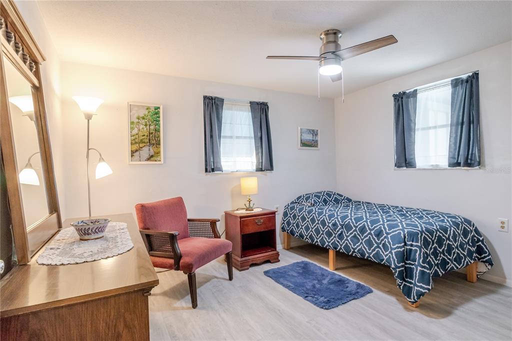 5644 Riddle Road Holiday, FL 34690 - Photo 27 of 58 a bedroom with furniture and a potted plant