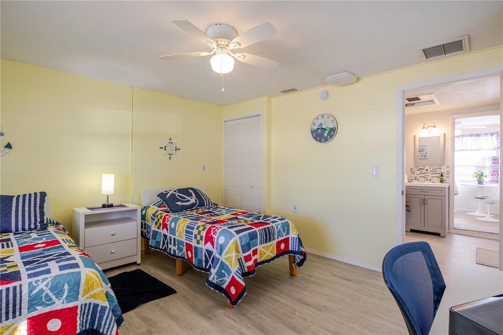 5644 Riddle Road Holiday, FL 34690 - Photo 30 of 58 a bedroom with a bed and a chandelier