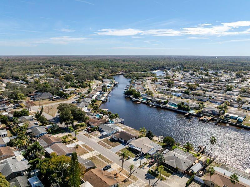 5644 Riddle Road Holiday, FL 34690 - Photo 54 of 58 an aerial view of a city with lots of residential buildings and ocean view in back