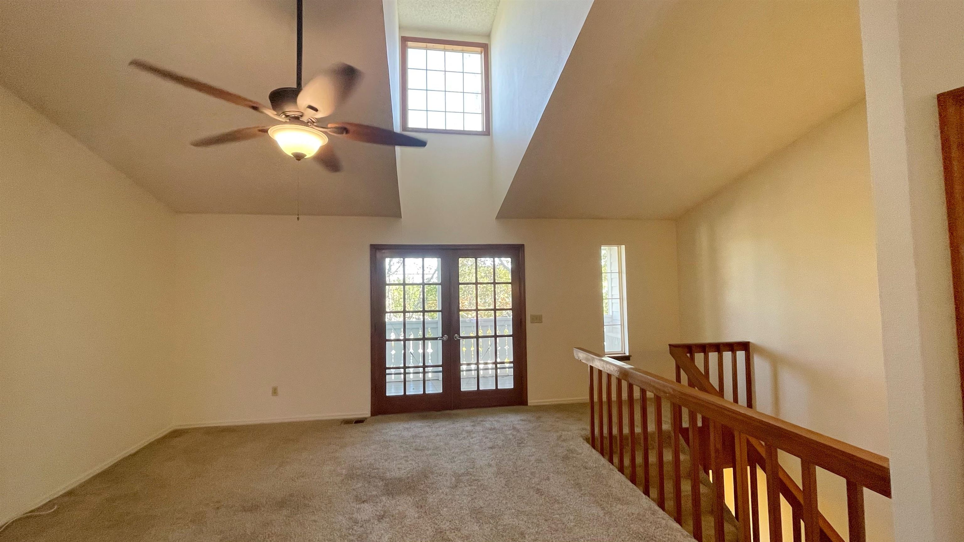 105 Arricola Avenue, Unit E St. Augustine, FL 32080 - Photo 19 of 27 an empty room with windows and ceiling fan