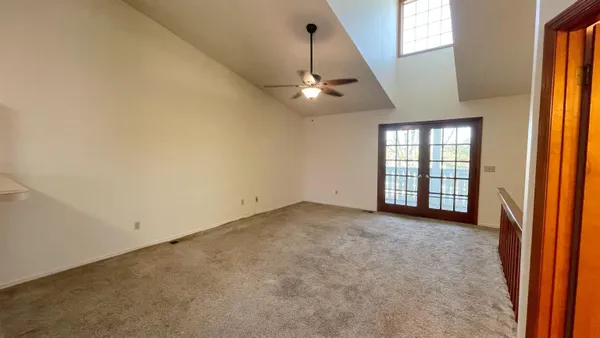 a view of kitchen with white cabinets and refrigerator
