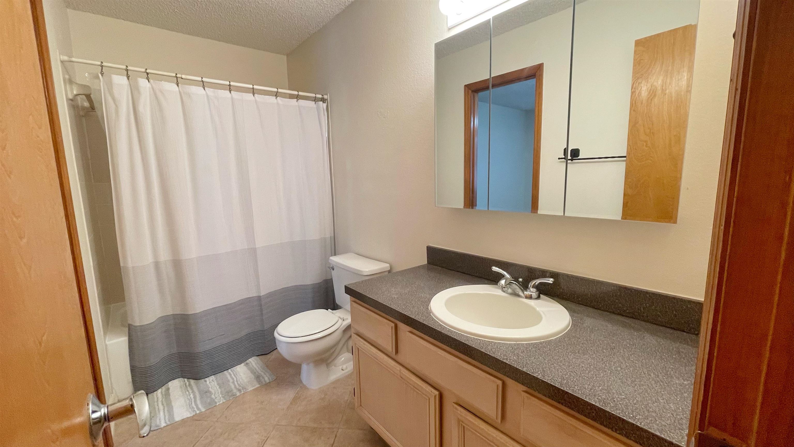 105 Arricola Avenue, Unit E St. Augustine, FL 32080 - Photo 8 of 27 a bathroom with a sink toilet and shower