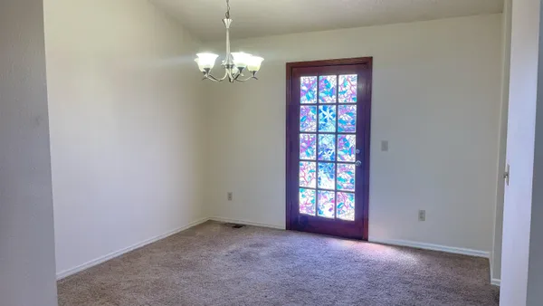 a view of a porch with furniture and floor to ceiling window