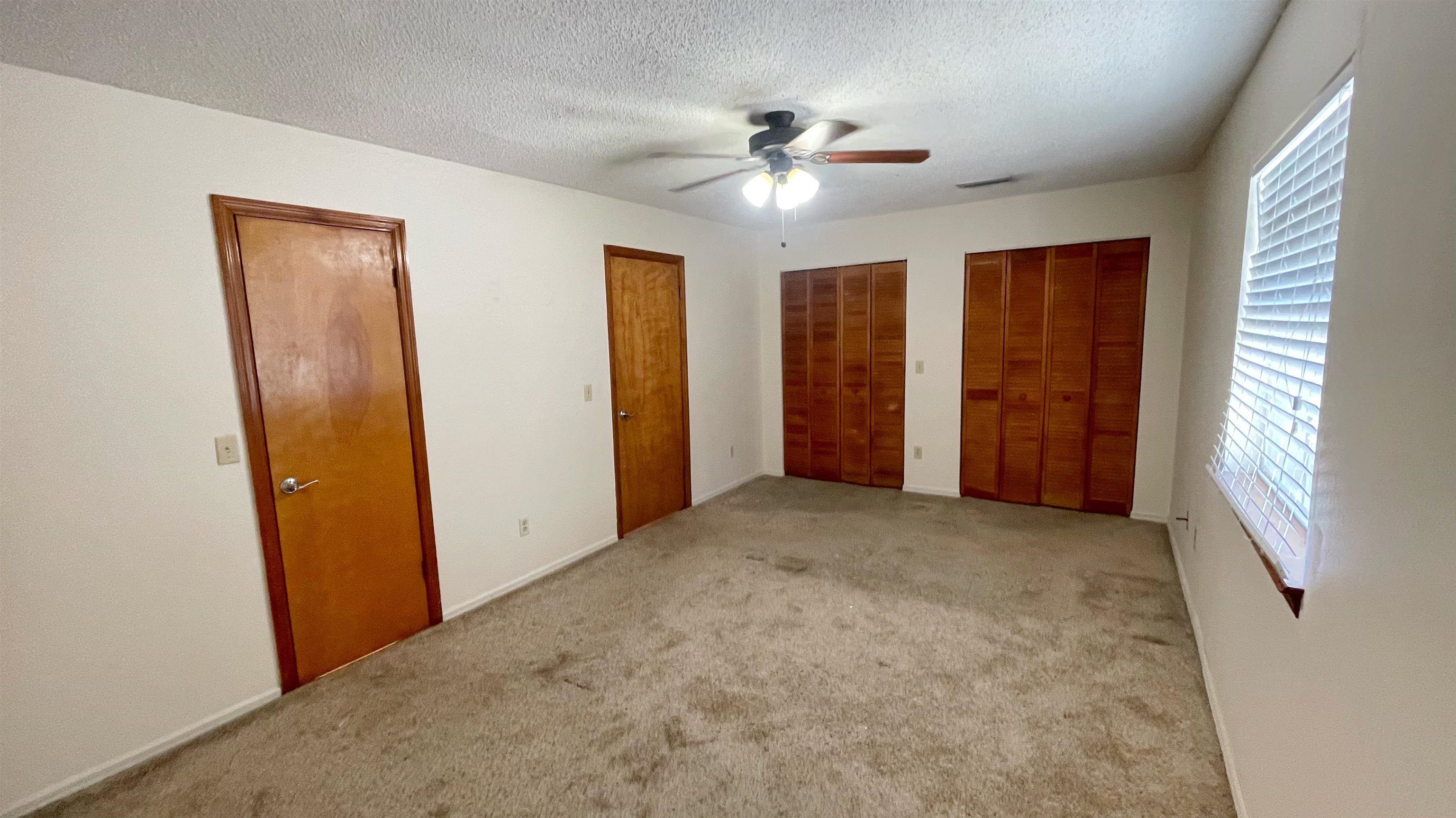 105 Arricola Avenue, Unit E St. Augustine, FL 32080 - Photo 10 of 27 an empty room with windows and closet