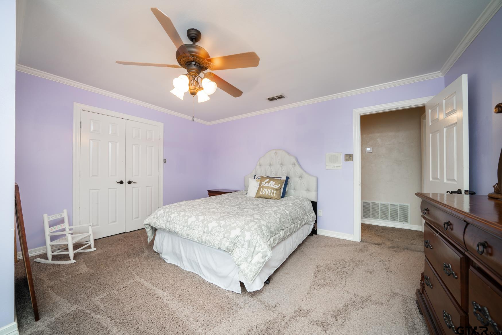 2 Joseph Circle Longview, TX 75601 - Photo 22 of 35 a bedroom with a bed and a chandelier