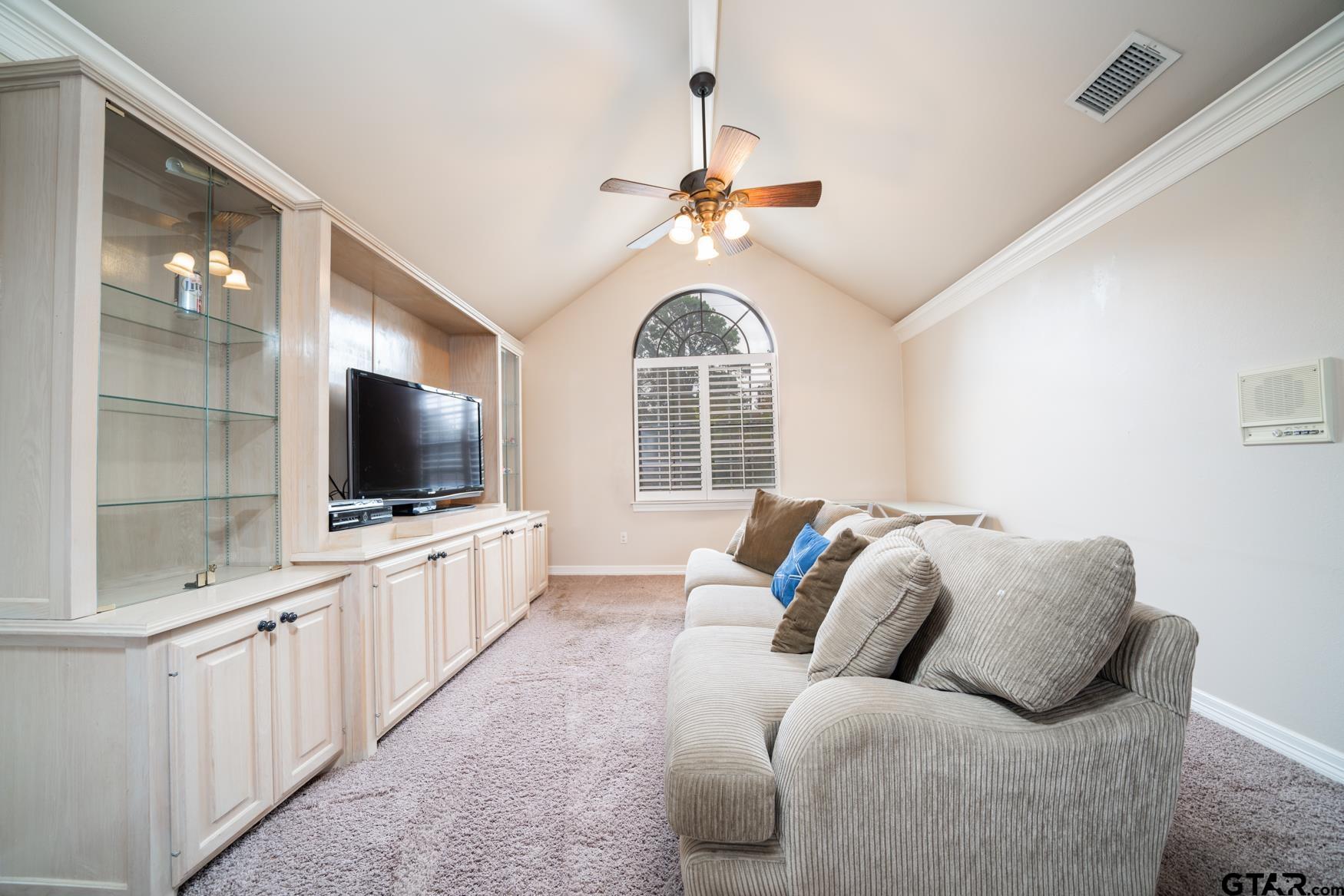 2 Joseph Circle Longview, TX 75601 - Photo 30 of 35 a living room with furniture a flat screen tv and a chandelier