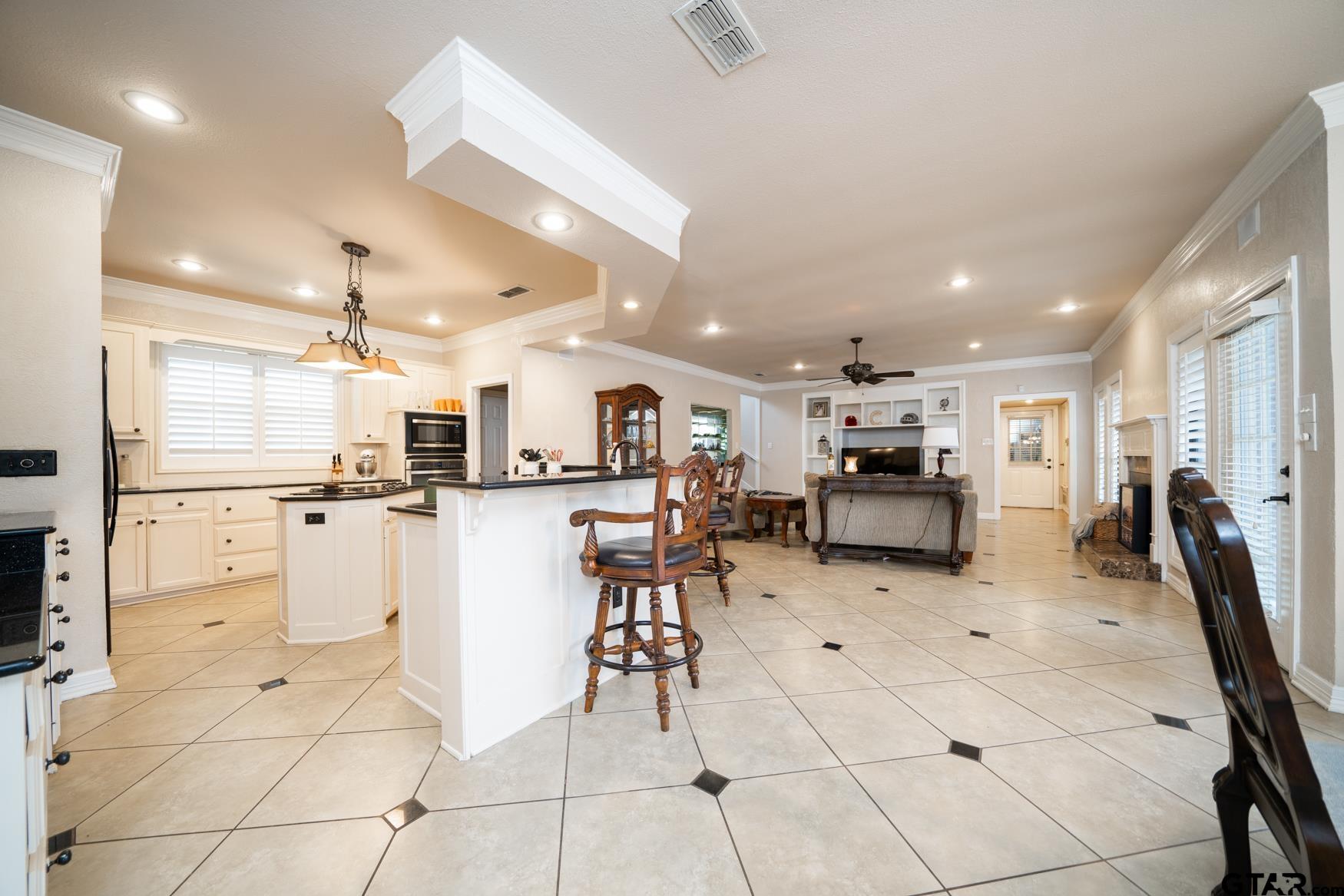 2 Joseph Circle Longview, TX 75601 - Photo 6 of 35 a large white kitchen with lots of counter space and chairs