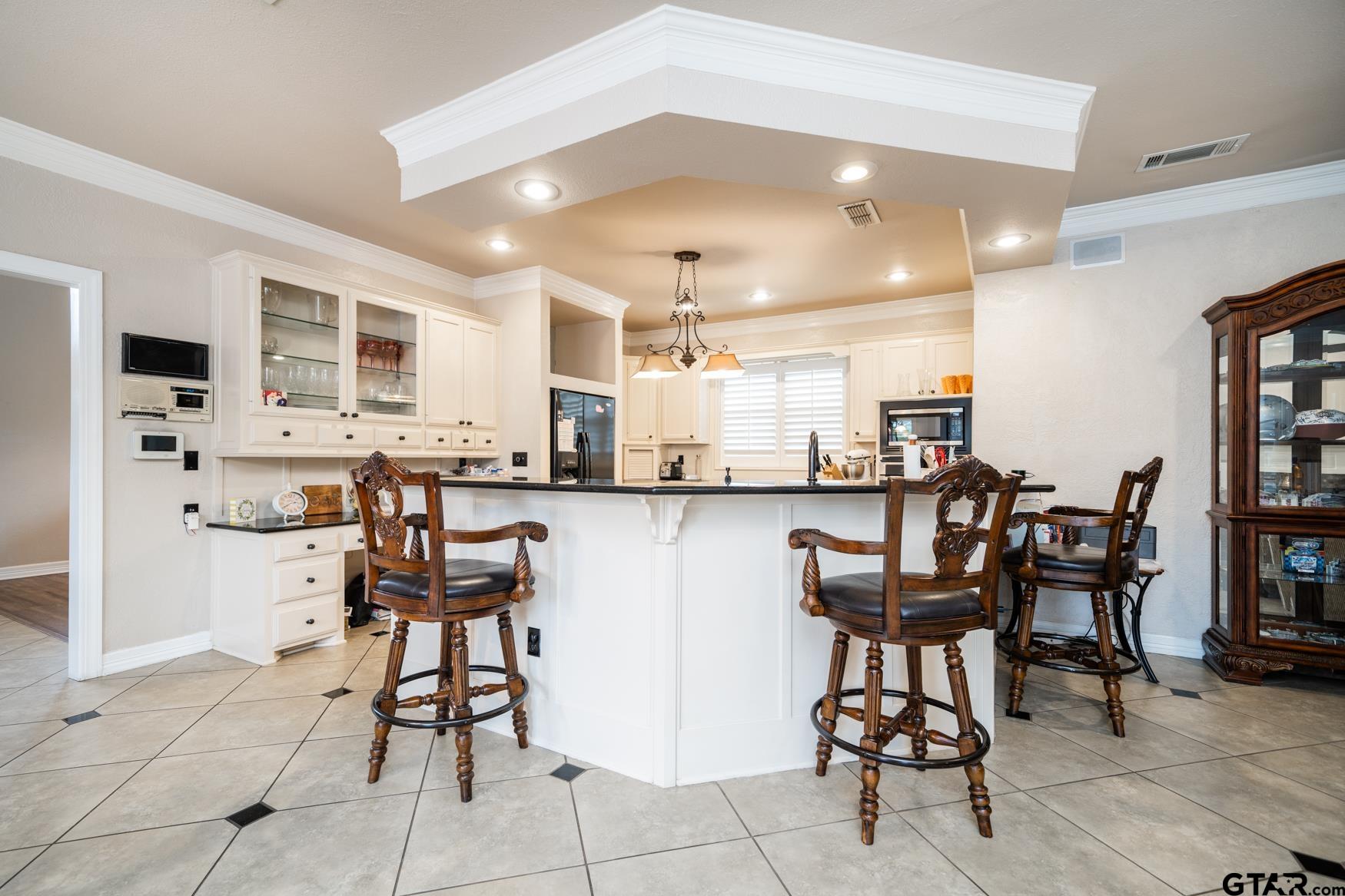 2 Joseph Circle Longview, TX 75601 - Photo 7 of 35 a kitchen with stainless steel appliances kitchen island granite countertop a table and chairs in it