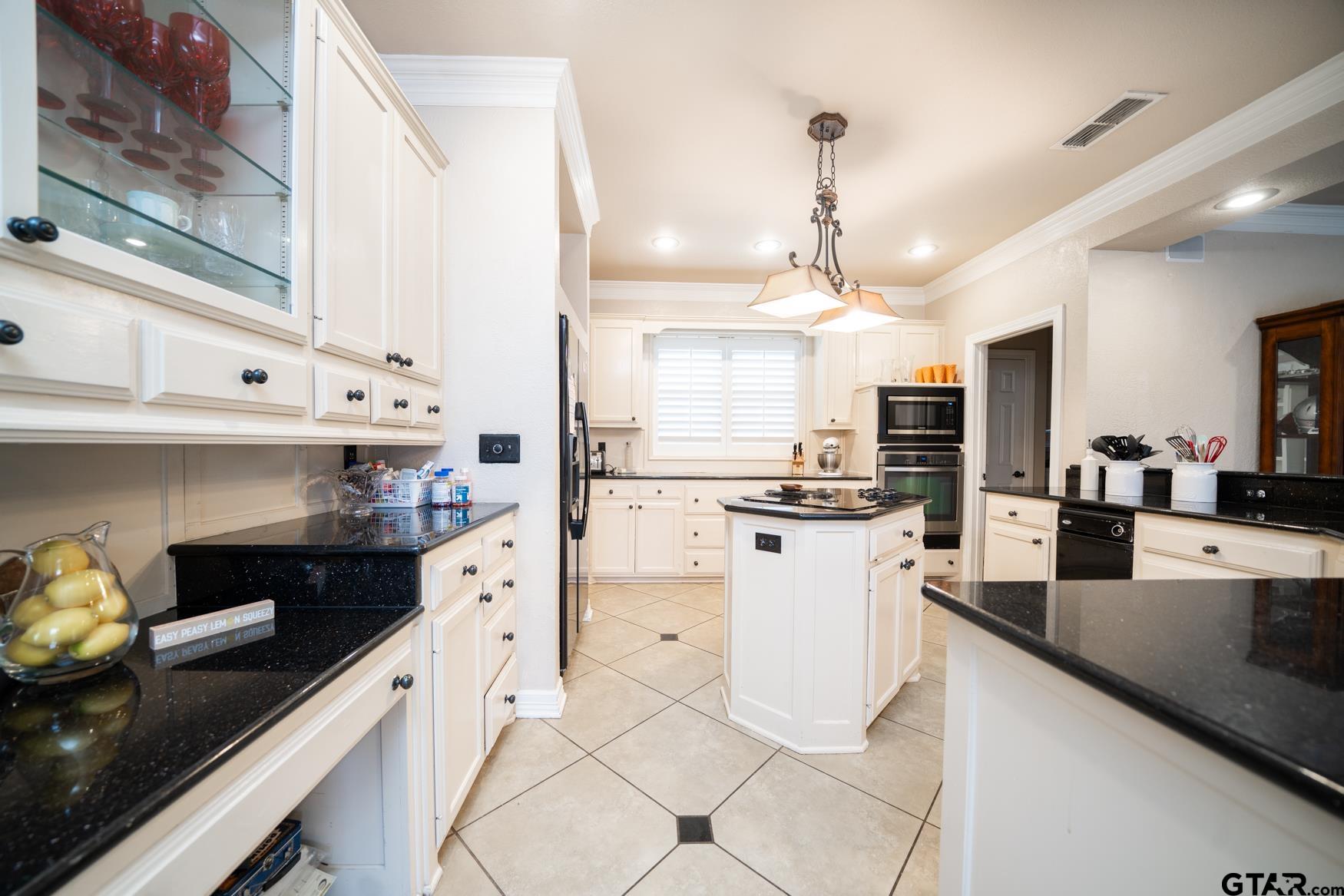 2 Joseph Circle Longview, TX 75601 - Photo 8 of 35 a kitchen with white cabinets and appliances