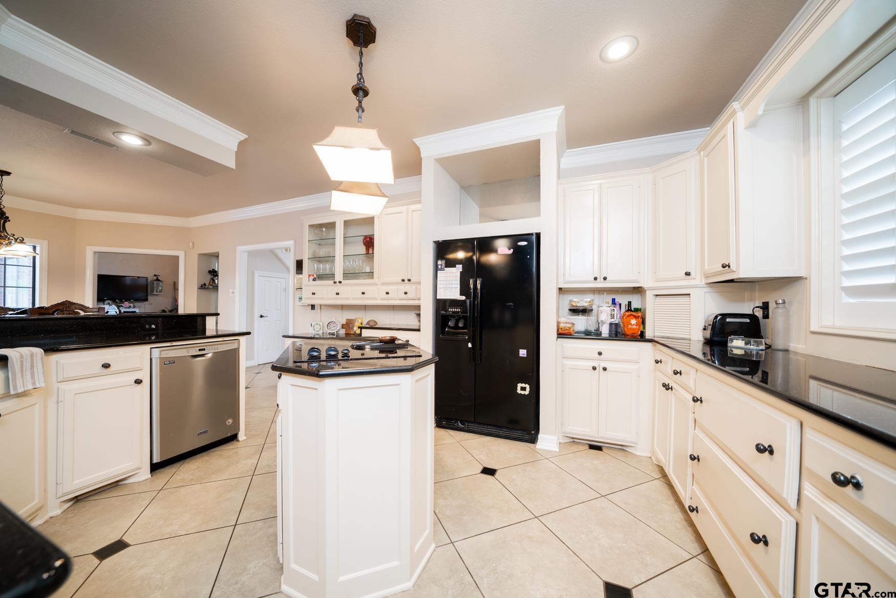 2 Joseph Circle Longview, TX 75601 - Photo 9 of 35 a kitchen with granite countertop a refrigerator a sink dishwasher a stove and white cabinets with wooden floor