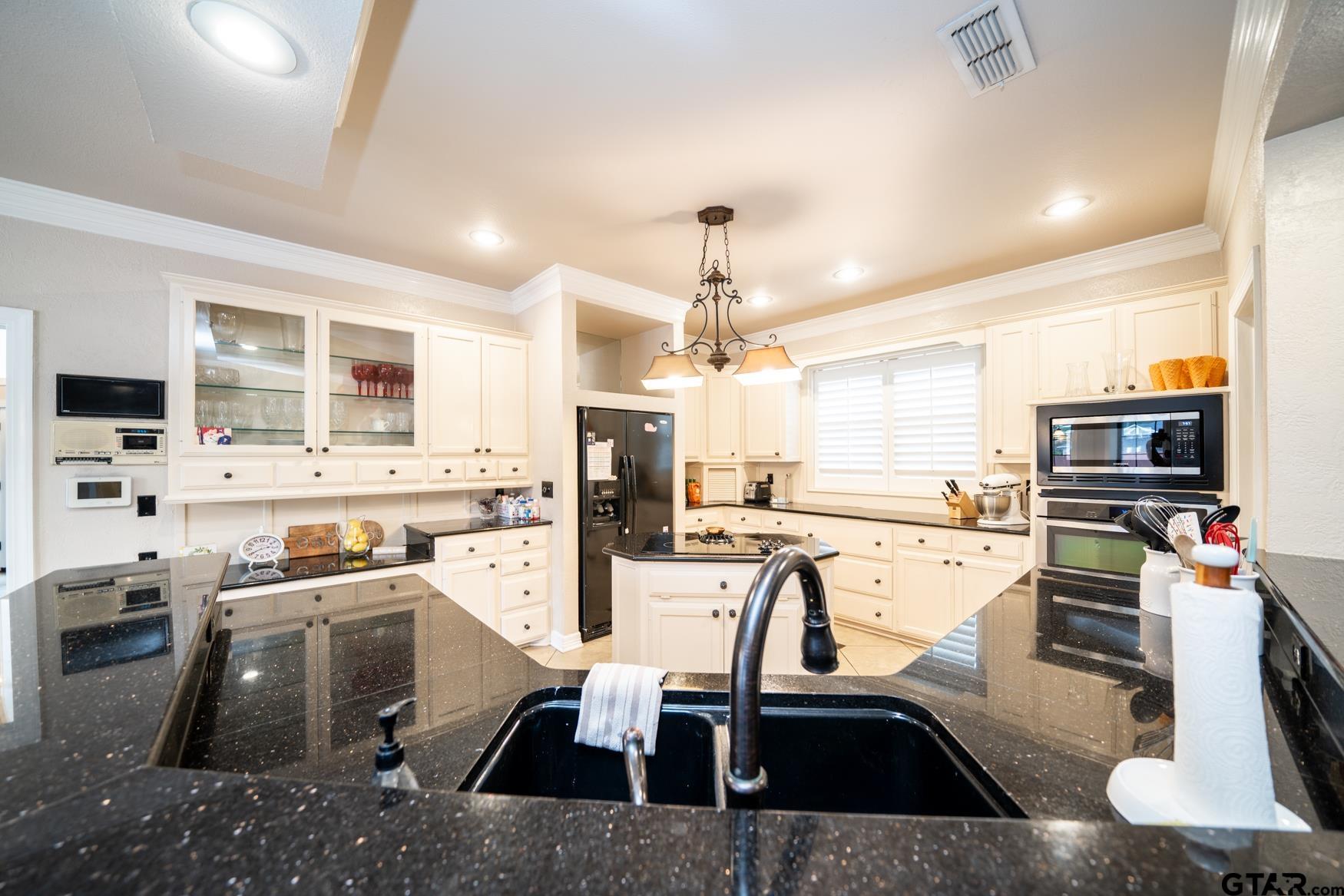2 Joseph Circle Longview, TX 75601 - Photo 10 of 35 a kitchen with a sink a counter top space stainless steel appliances and cabinets