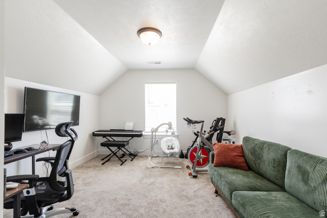 349 West 3085 South Logan, UT 84321 - Photo 26 of 37 Attic room featuring a single window, sloped ceilings, wall-to-wall carpeting, and a ceiling-mounted light fixture