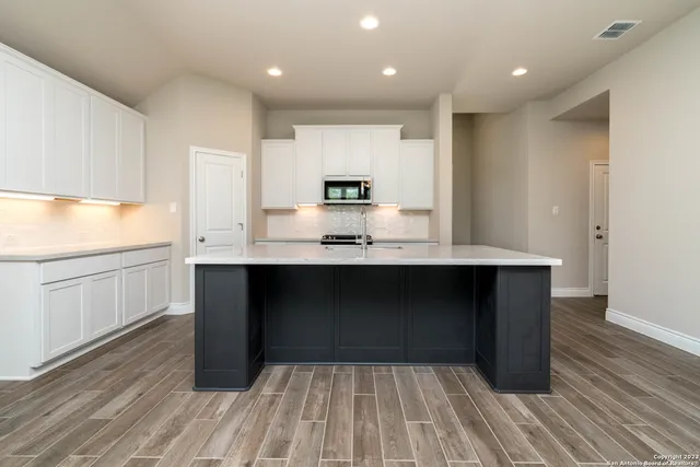 a bathroom with a sink and a large mirror