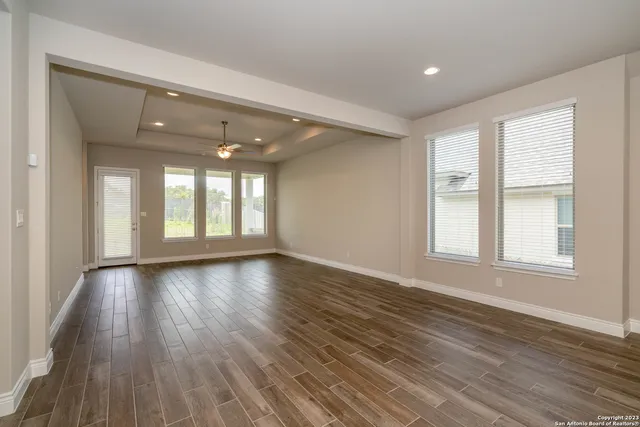 a large kitchen with a lot of counter space and wooden floor