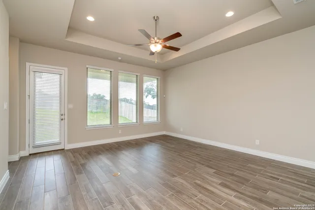 an empty room with closet and a ceiling fan